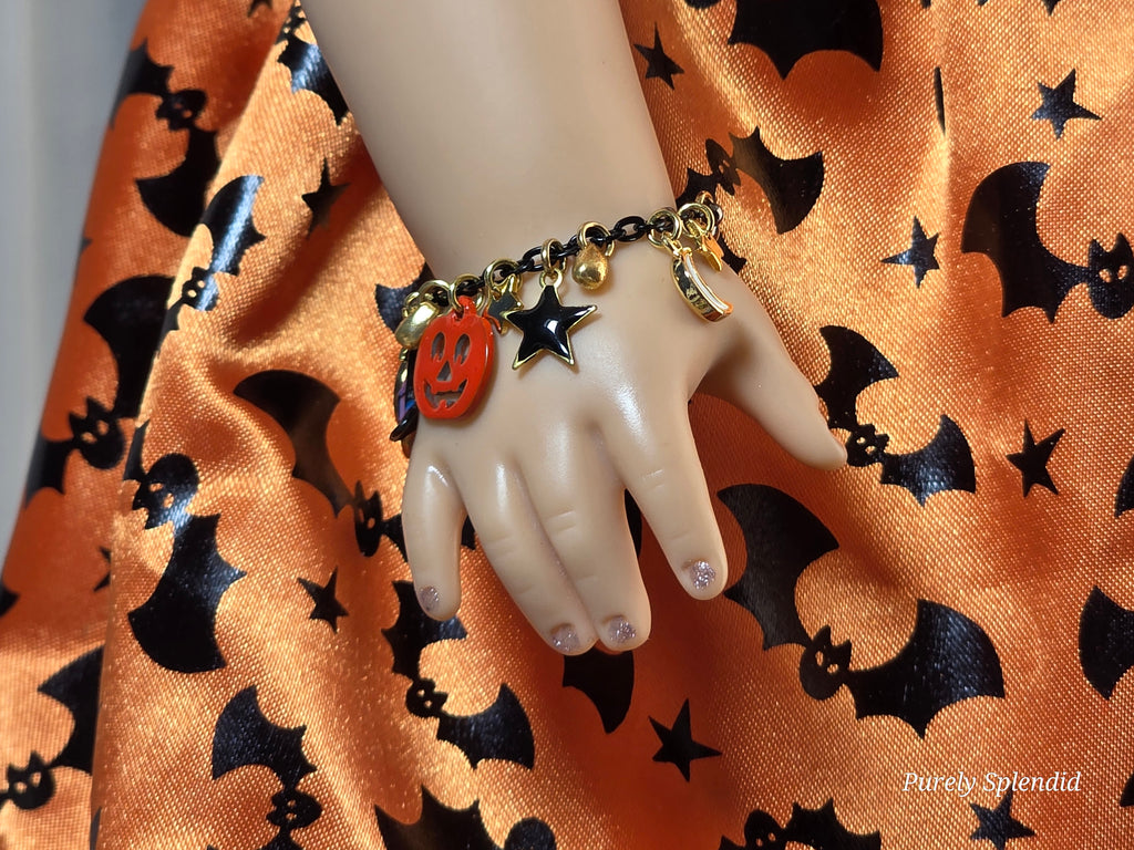 18 inch doll wearing a Halloween charm bracelet 