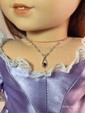dainty amethyst pendant on a silver twisted chain worn by an 18 inch doll