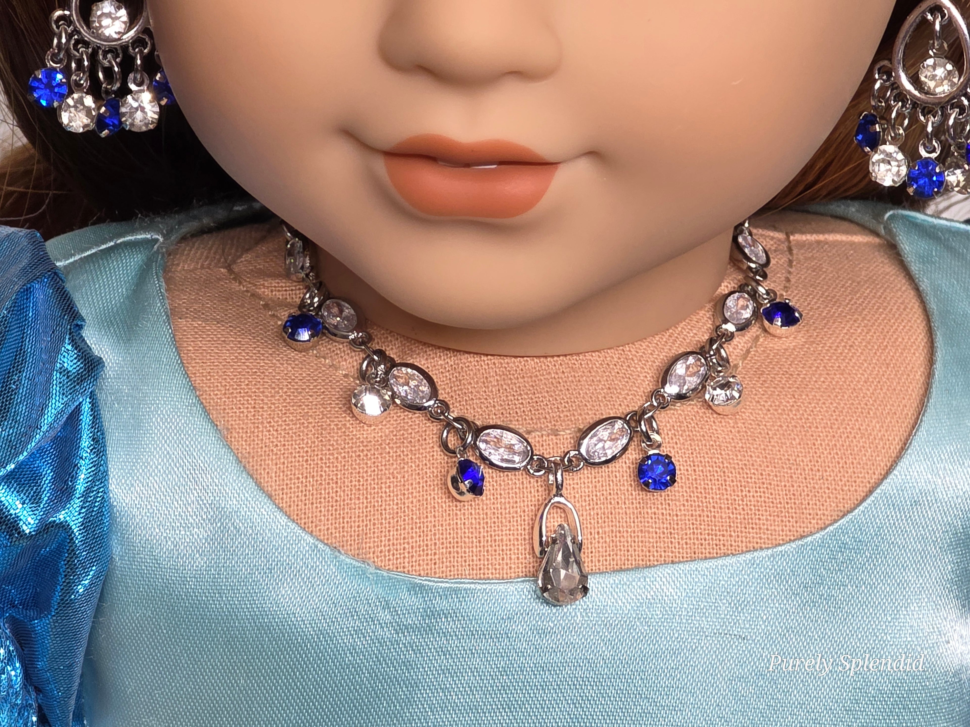 18 inch doll wearing a Princess Necklace with blue and clear crystals. American made / Purely Splendid
