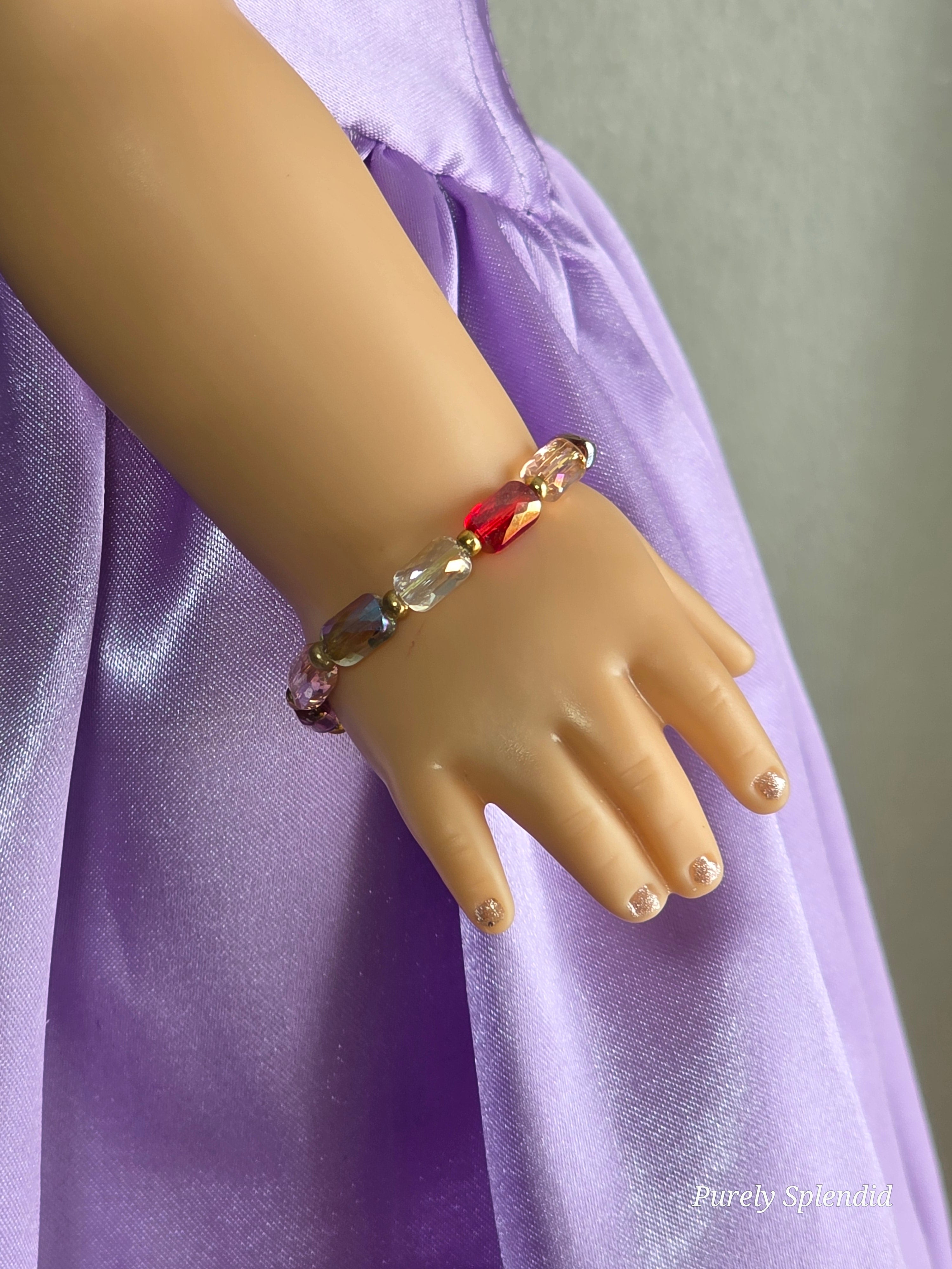 18 inch doll wearing multi-colored crystal bracelet