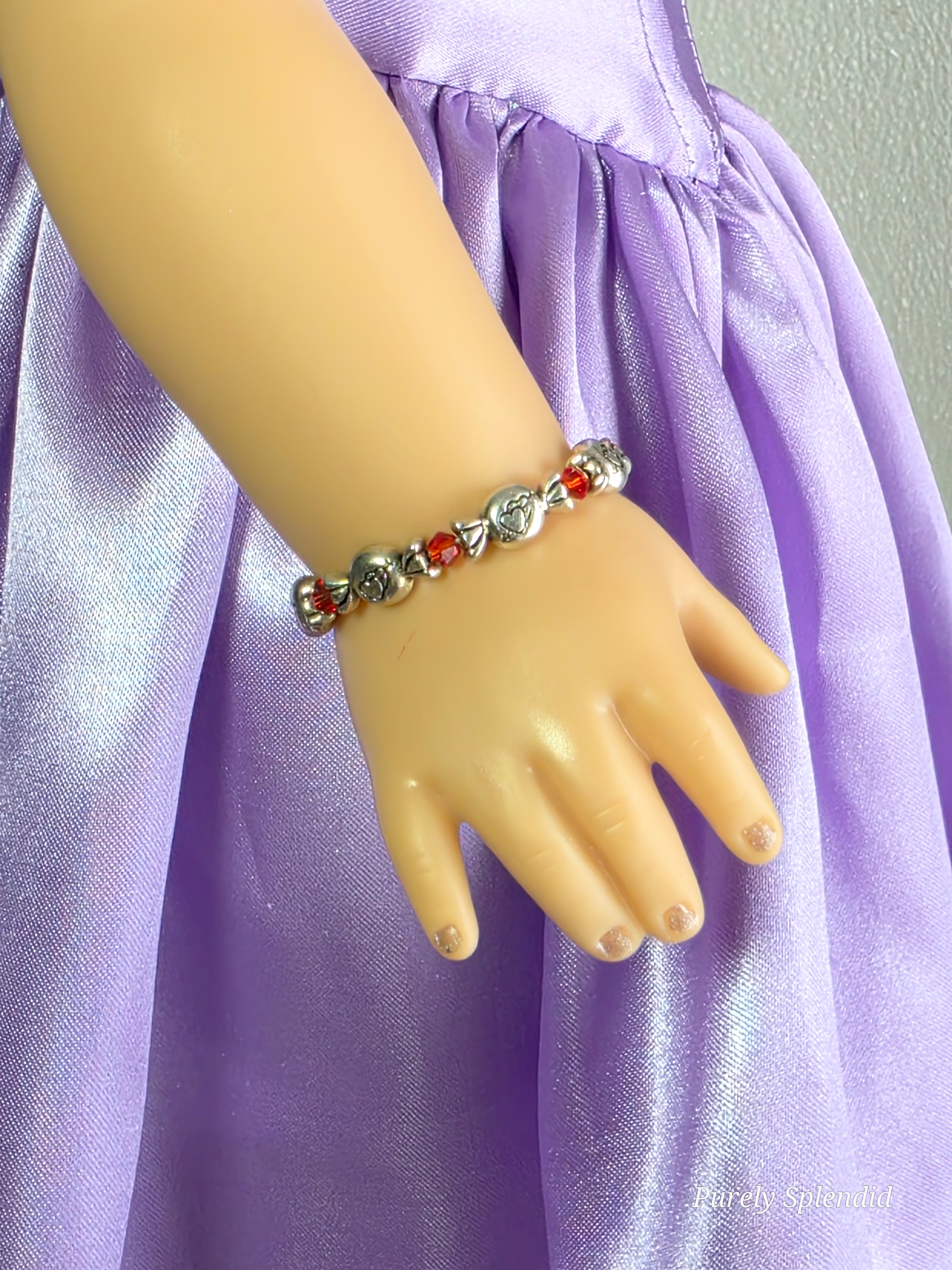 18 inch doll wearing Valentine candy bracelet with hearts on the candies