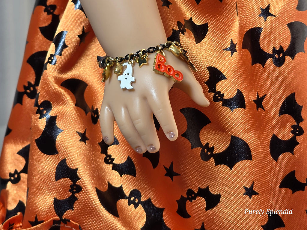 18 inch doll wearing a Halloween charm bracelet