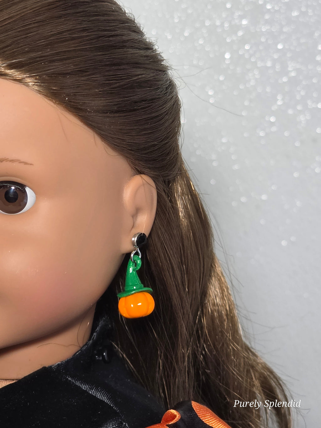 18 inch doll wearing pumpkin earrings