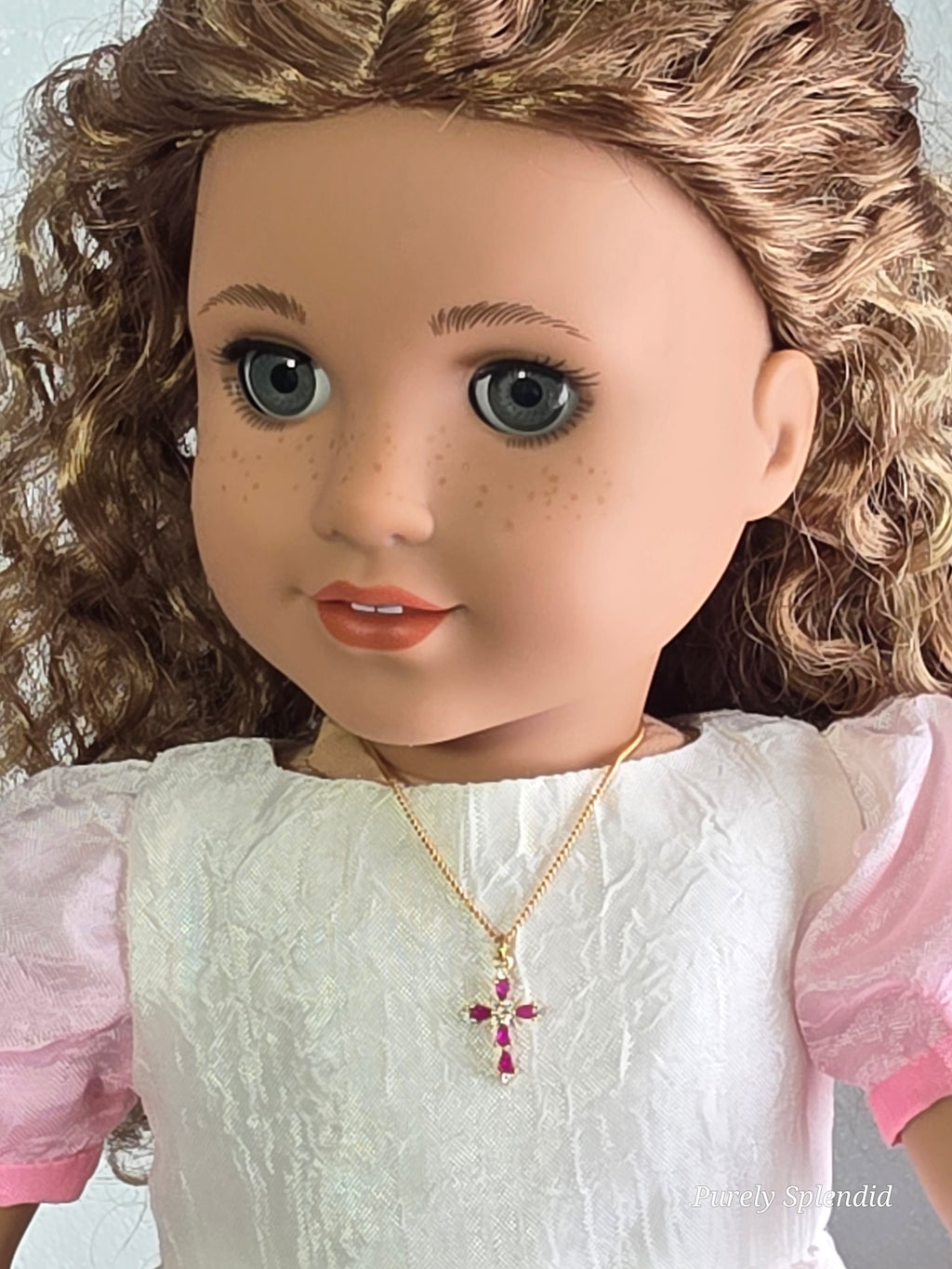 18 inch doll wearing cranberry cross necklace - American made religious jewelry with magnetic clasp
