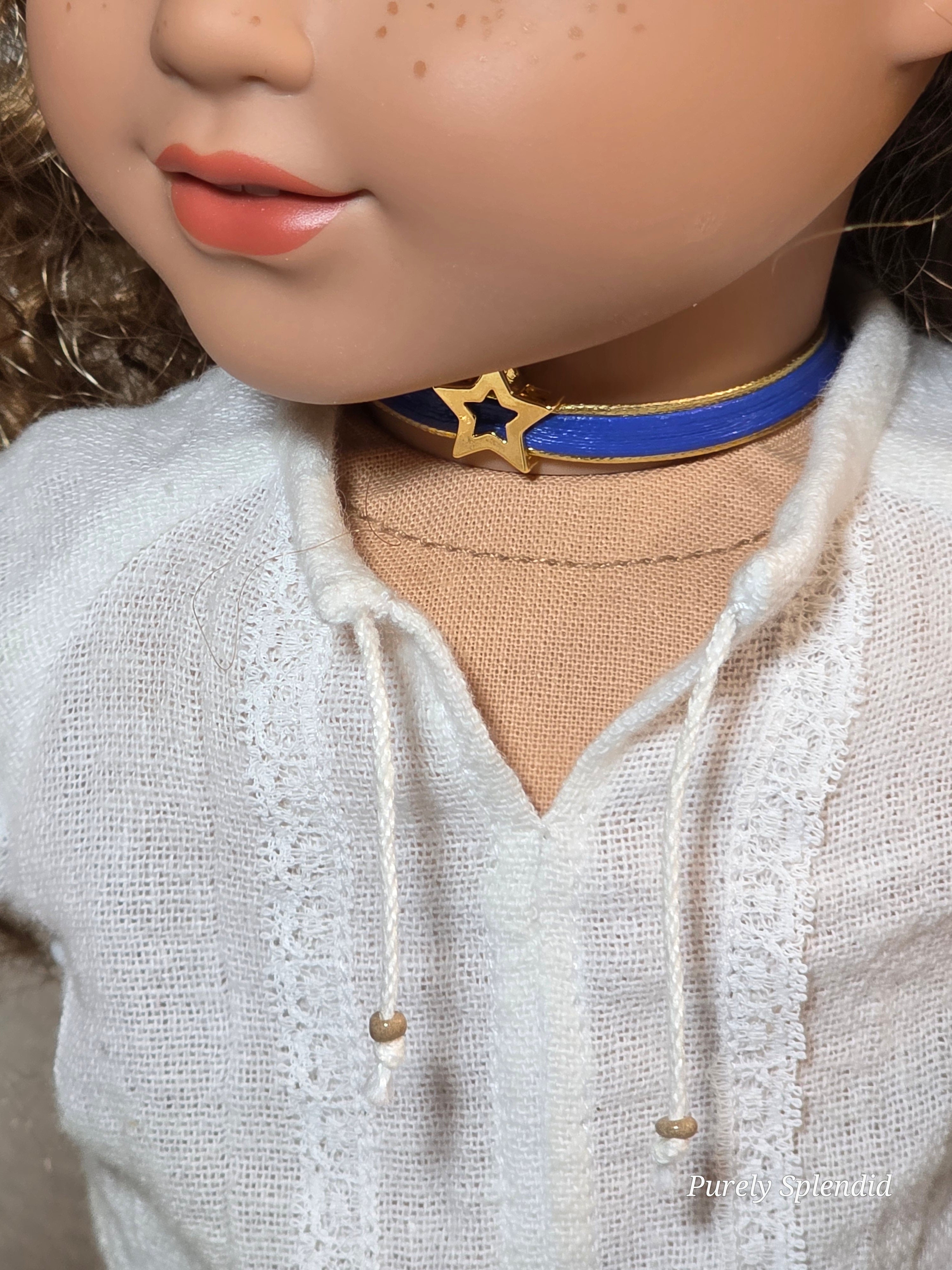18 inch girl doll wearing a gold star choker with blue band American made / Purely Splendid