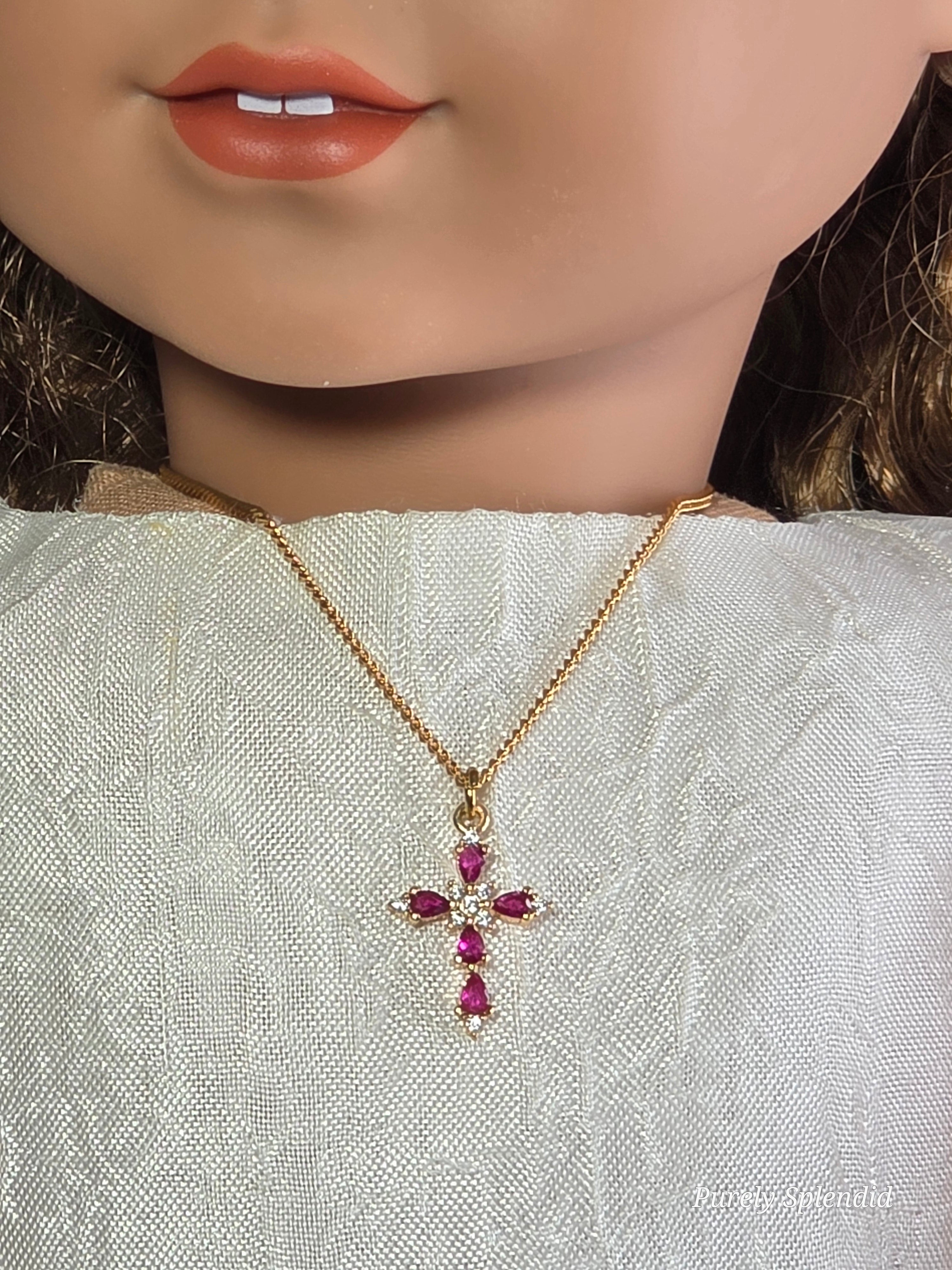 18 inch doll wearing a Cranberry Cross Necklace on a gold chain