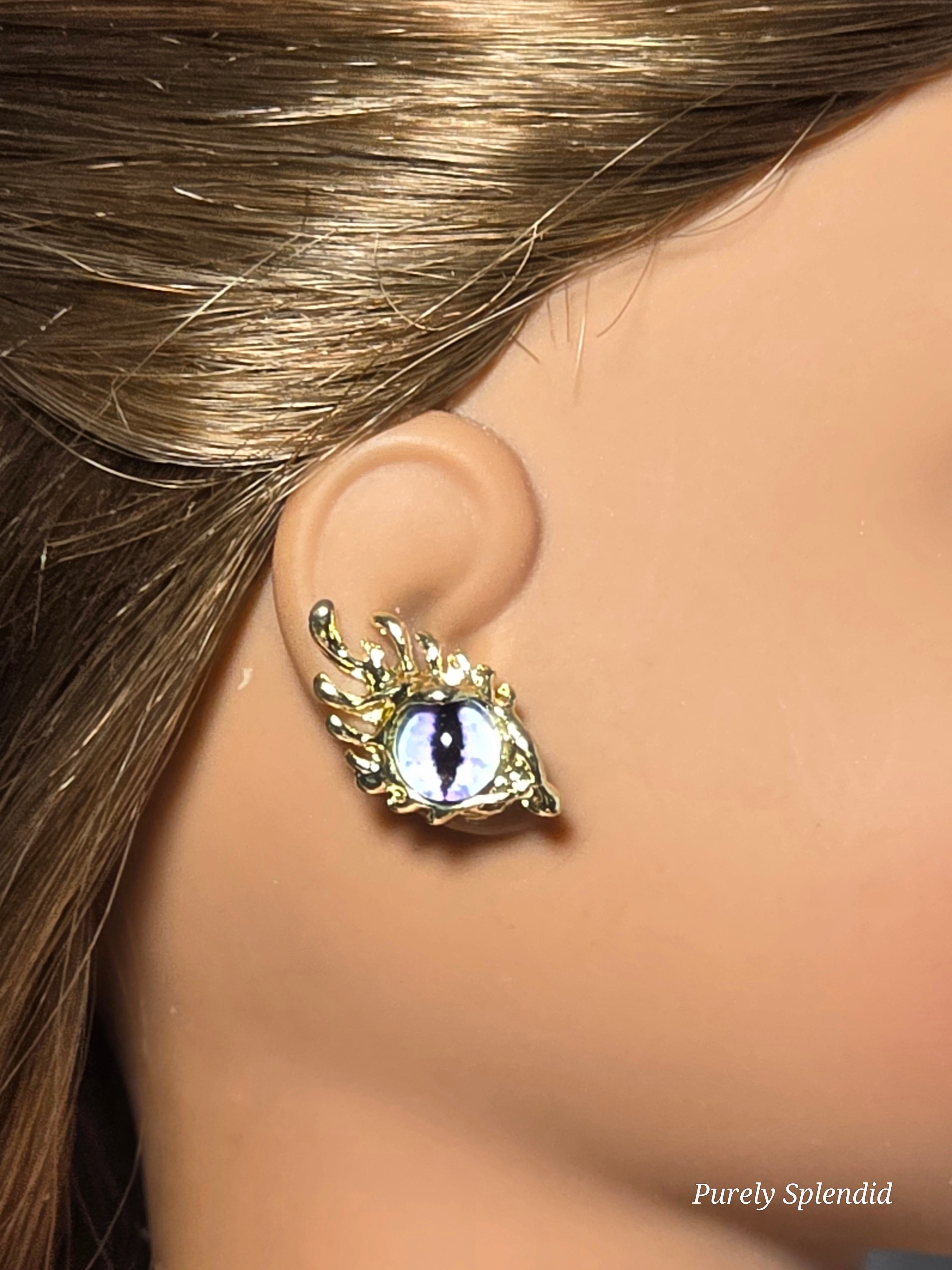 18 inch doll wearing a pair of purple eye studs with fancy lashes