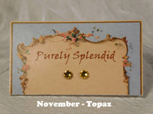 Load image into Gallery viewer, a pair of November Birthstone Topaz Studs on a display card
