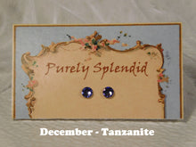 Load image into Gallery viewer, pair of tanzanite 2mm stud earrings shown on a display card
