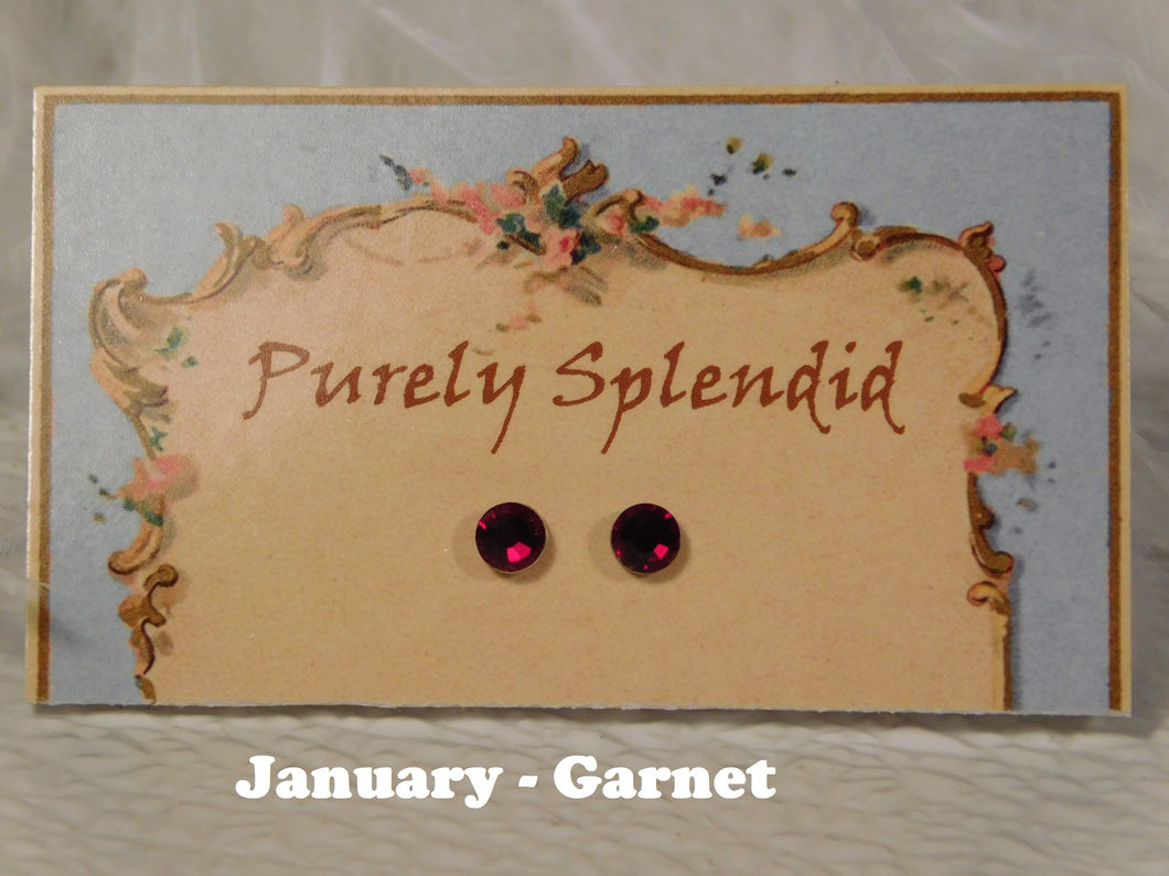a pair of January - Garnet Birthstone studs on display card 