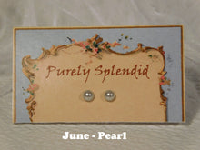 Load image into Gallery viewer, a pair of June Birthstone Pearl Studs on a display card
