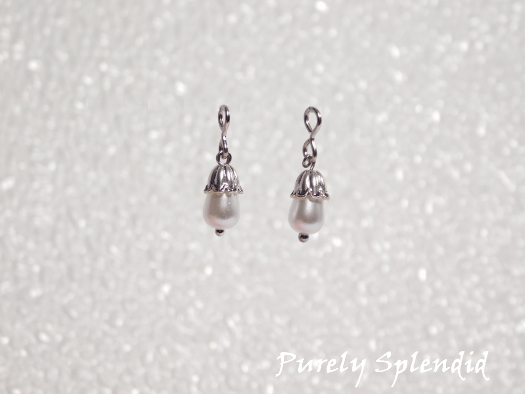 white teardrop pearls with a silver petal cap 