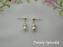 Load image into Gallery viewer, Girl Doll &amp; ME earrings shown. Teardrop white pearls with a silver bead at the bottom and silver flower cap on top.

