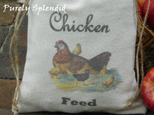 Load image into Gallery viewer, close up of a Mother Hen sitting on her nest with her chicks and the words Chicken Feed printed on the bag

