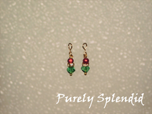 Load image into Gallery viewer, Green crystal bead topped with a ring of golden sparkles and a cherry red pearl.
