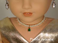 Load image into Gallery viewer, 18 inch doll shown all dressed up wearing a string of white pearls with a sparkling green center pendant
