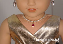Load image into Gallery viewer, 18 inch doll shown all dressed up wearing a string of white pearls with a sparkling red center pendant
