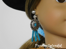 Load image into Gallery viewer, 18 inch doll shown wearing a pair of Conchos Dangles and Small Silver Studs. The silver colored concho has a turquoise center with 3 turquoise strands hanging below and a decorative silver colored bead above.
