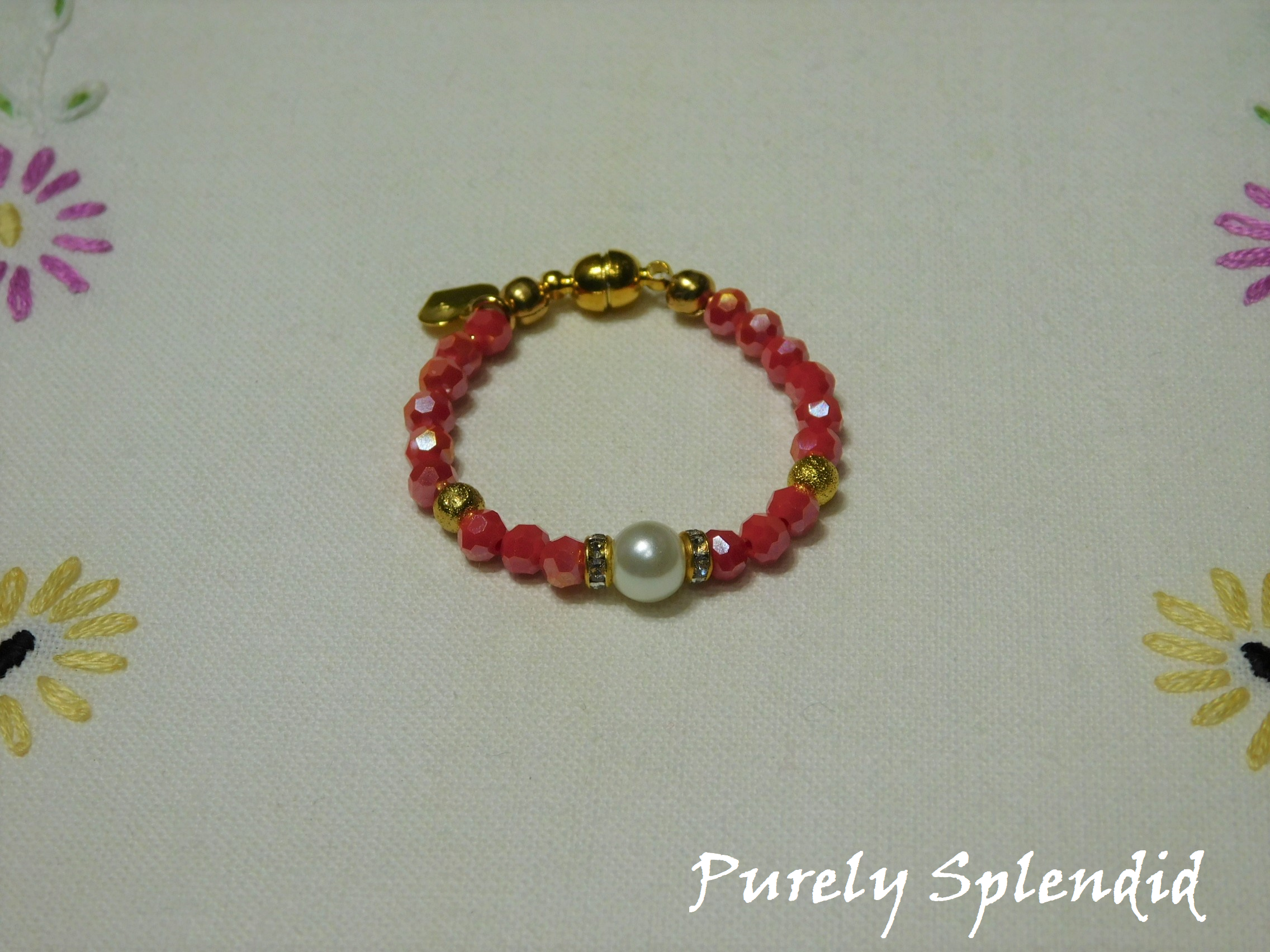 Beautiful Coral Crystal beads make this Crystal Evening Bracelet look lovely! A large white pearl flanked by a ring of sparkle is the focal point.