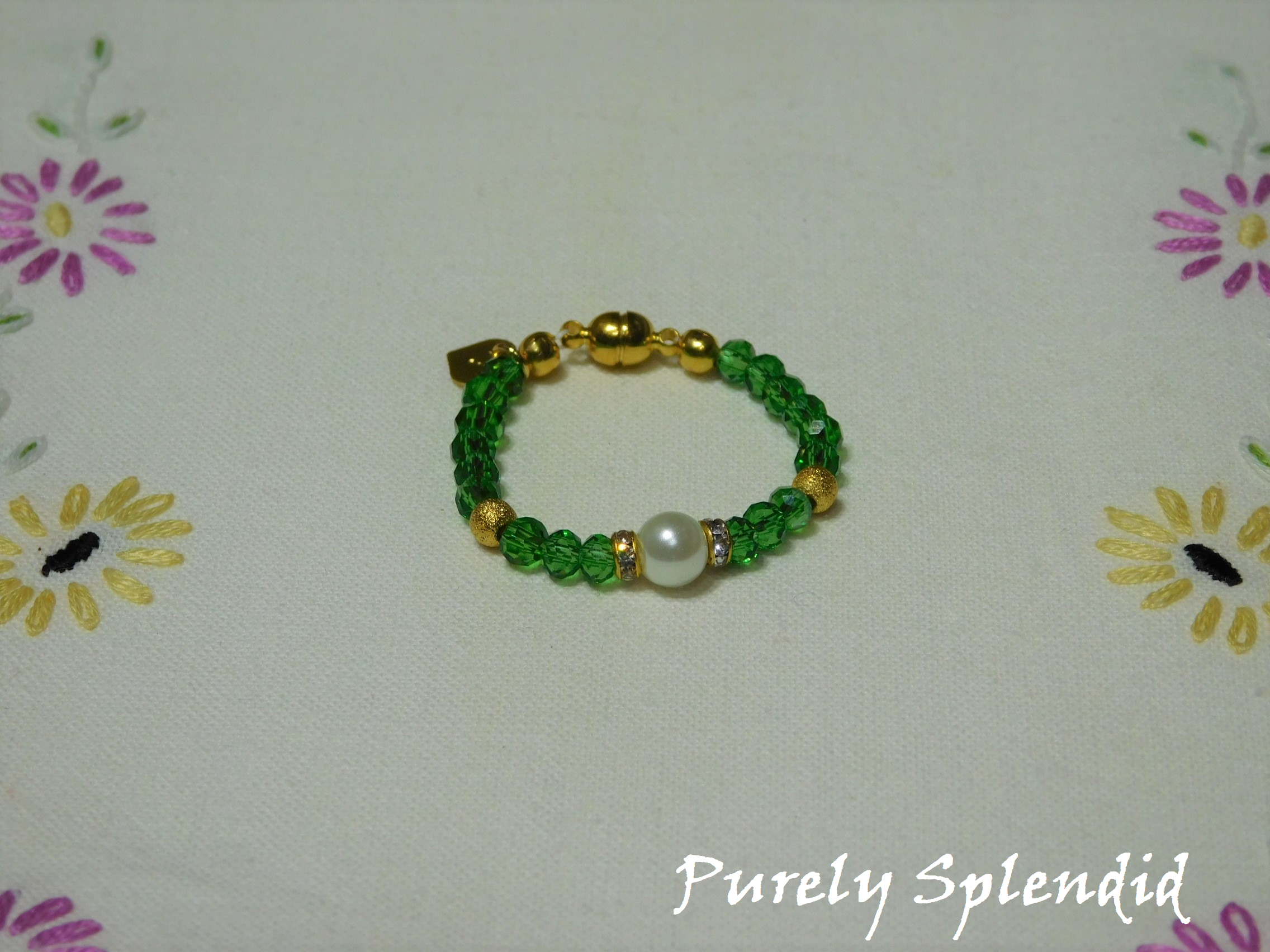 Beautiful Lime Green Crystal beads make this Crystal Evening Bracelet look lovely! A large white pearl flanked by a ring of sparkle is the focal point.