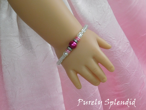 Crystal Stacking Bracelet with Magenta accents shown on an 18 inch doll