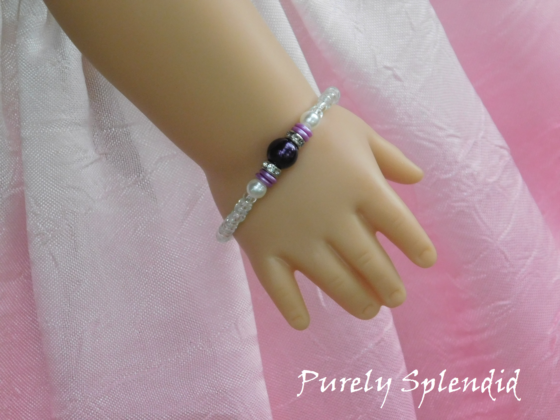 Crystal Stacking Bracelet with Purple accents shown on an 18 inch doll