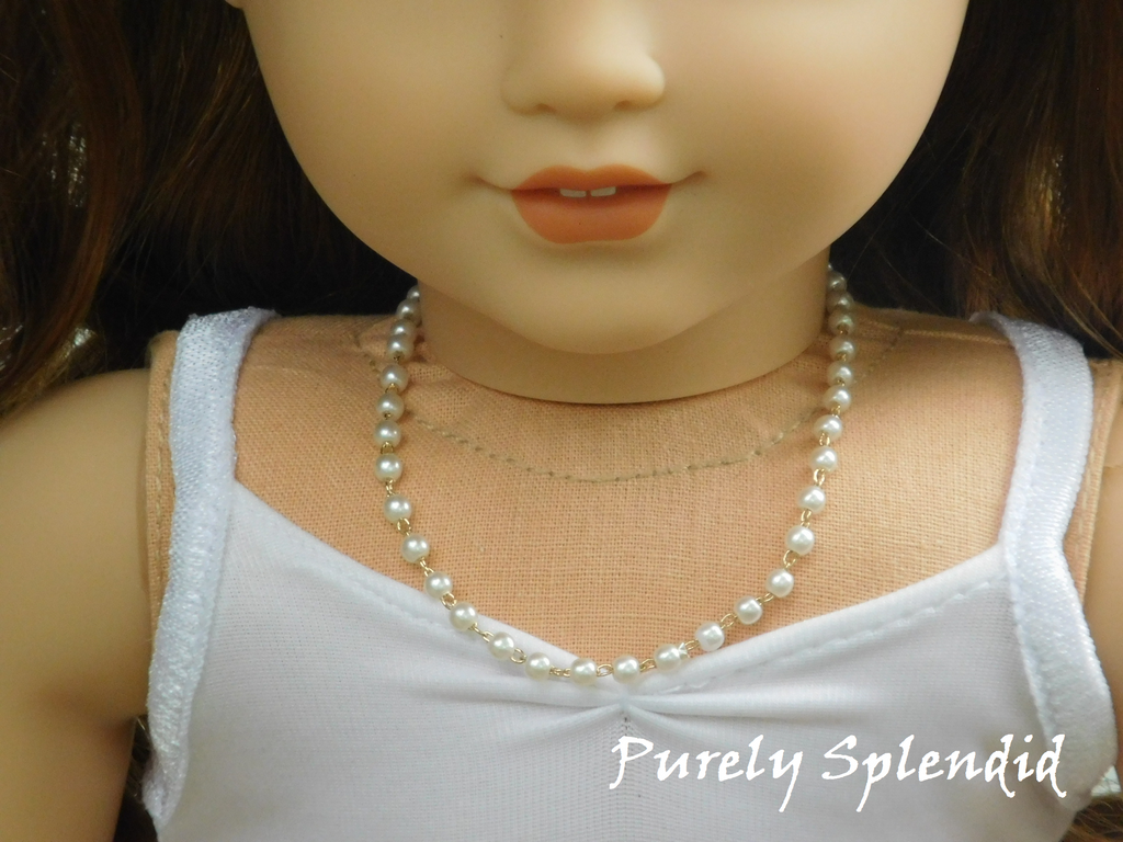 Tiny pearl like beads make up this Dainty Pearl Necklace -short version shown on an 18 inch doll