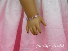 Load image into Gallery viewer, ten small purple daisy like flowers make up this Dainty Purple Flower Bracelet shown worn by an 18 inch doll
