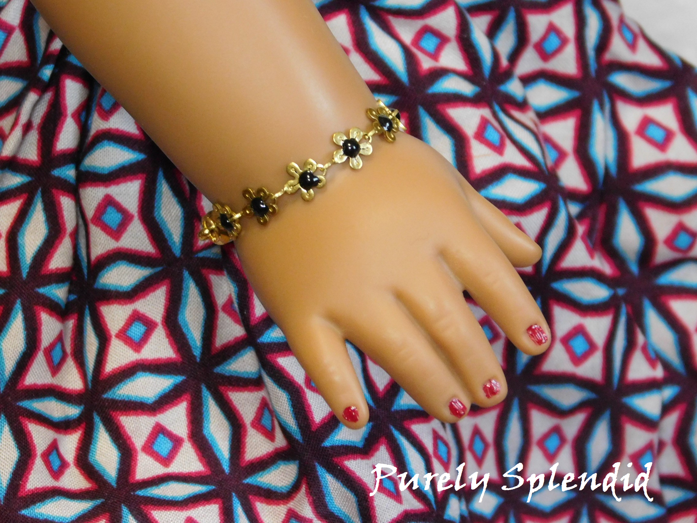 18 inch doll shown wearing a Daisy Flower Bracelet. Brass colored daisies with black centers.