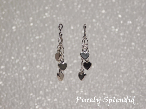 three dangling silver colored hearts make up these pretty Dangling Heart Earrings