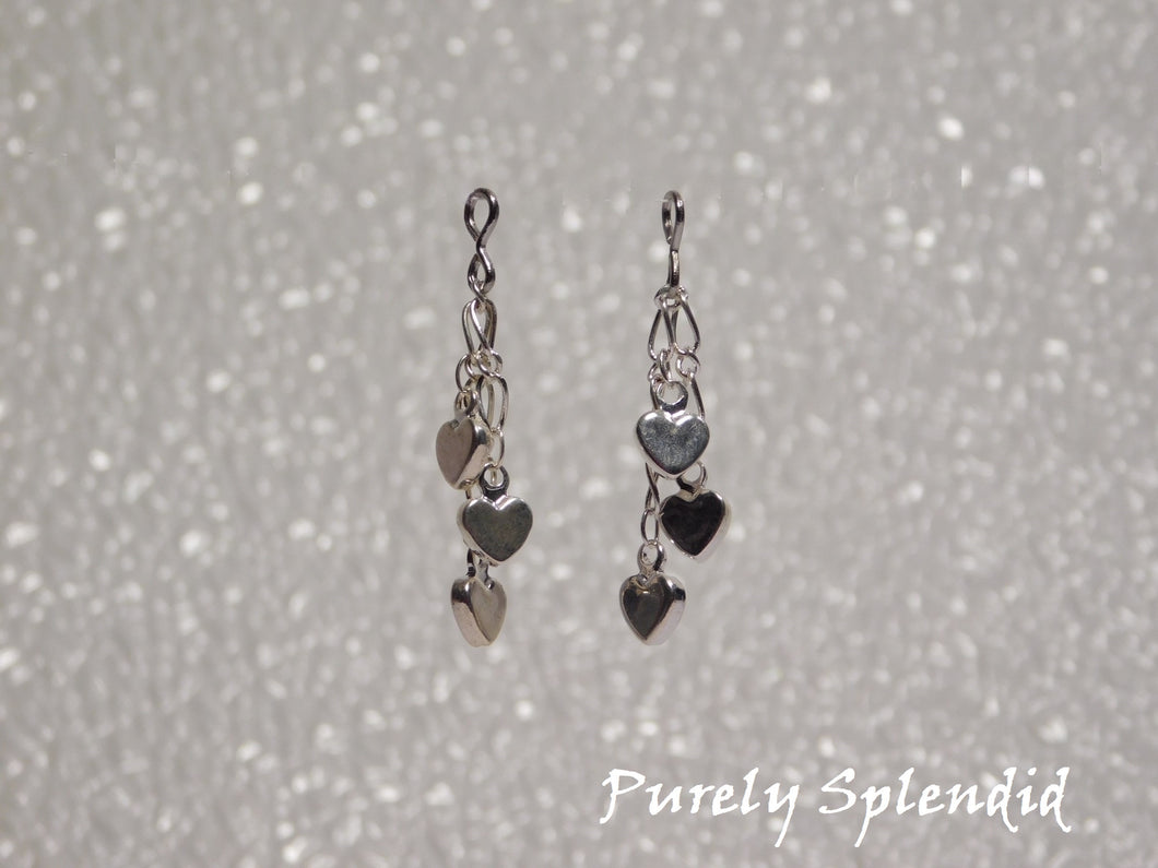 three dangling silver colored hearts make up these pretty Dangling Heart Earrings