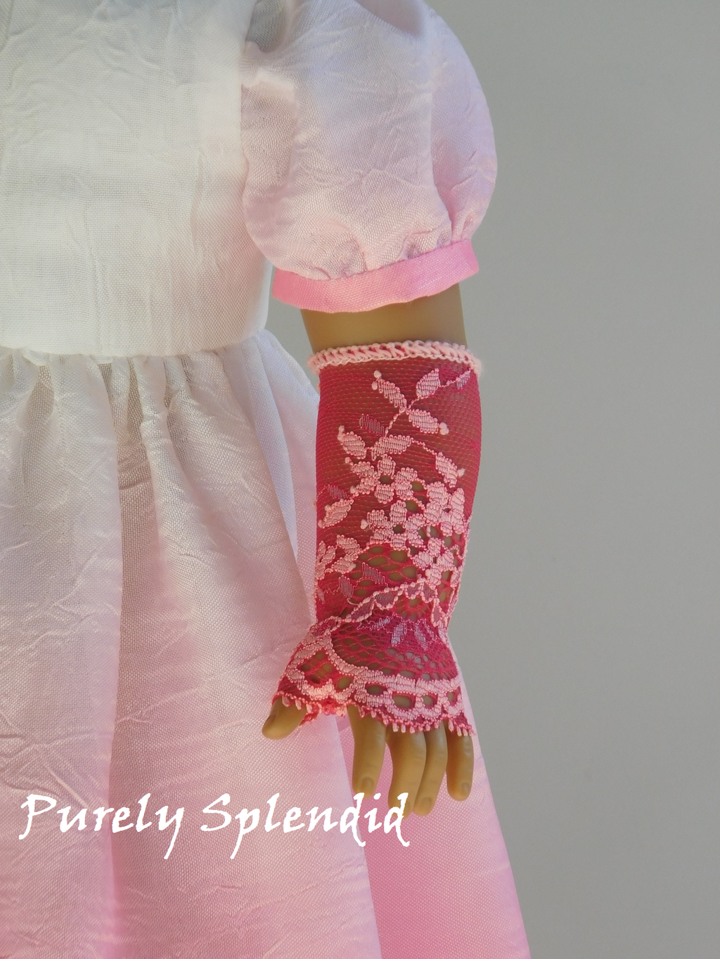 18 inch doll wearing a pair of Lacy Pink Fingerless Gloves