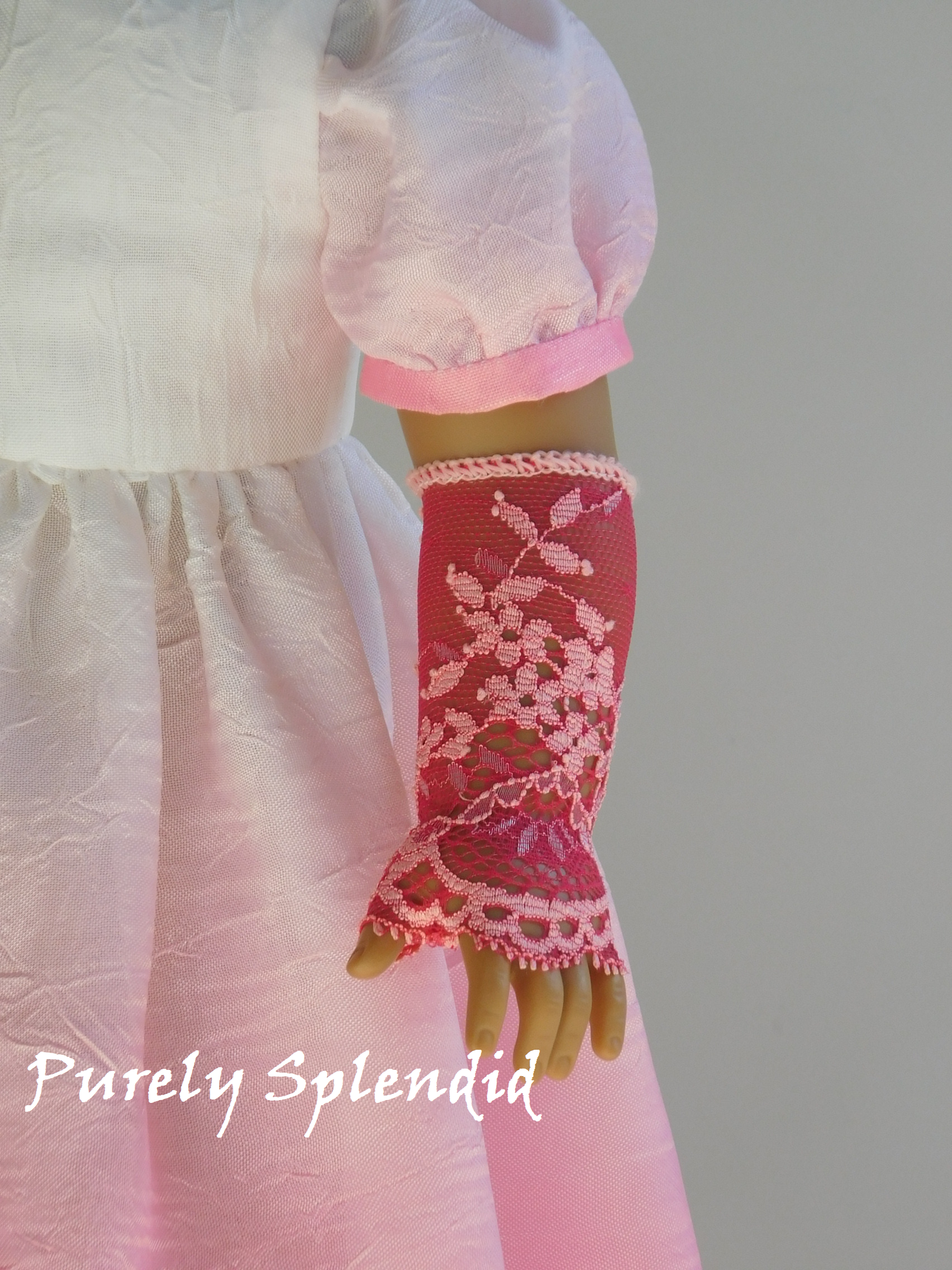 18 inch doll wearing a pair of Lacy Pink Fingerless Gloves