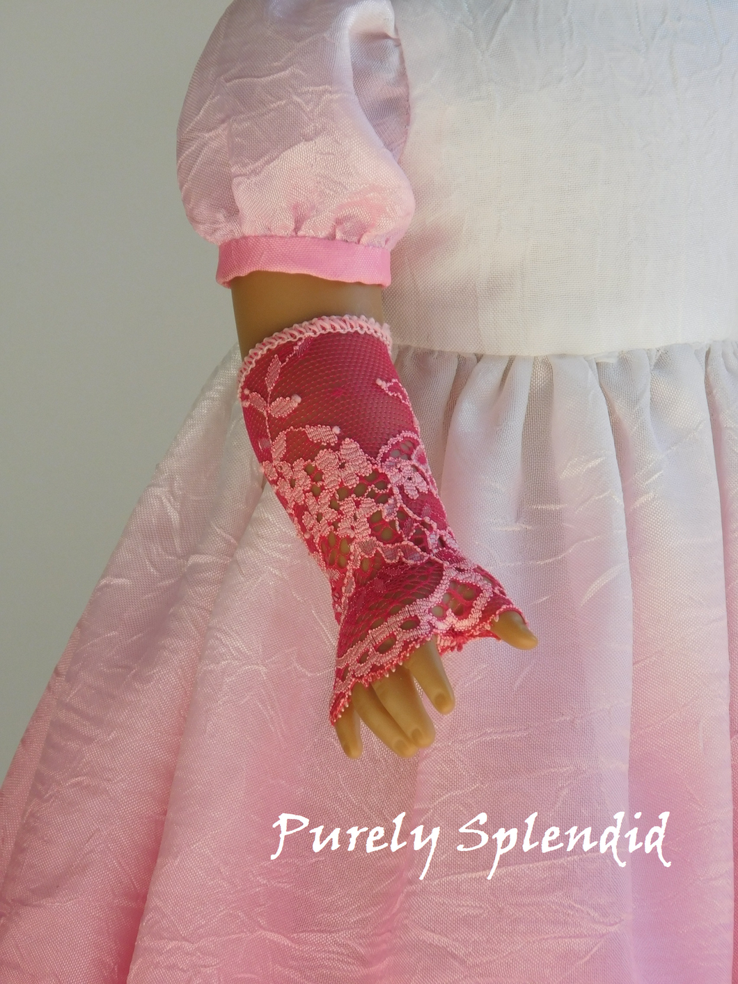 18 inch doll wearing a pair of Lacy Pink Fingerless Gloves