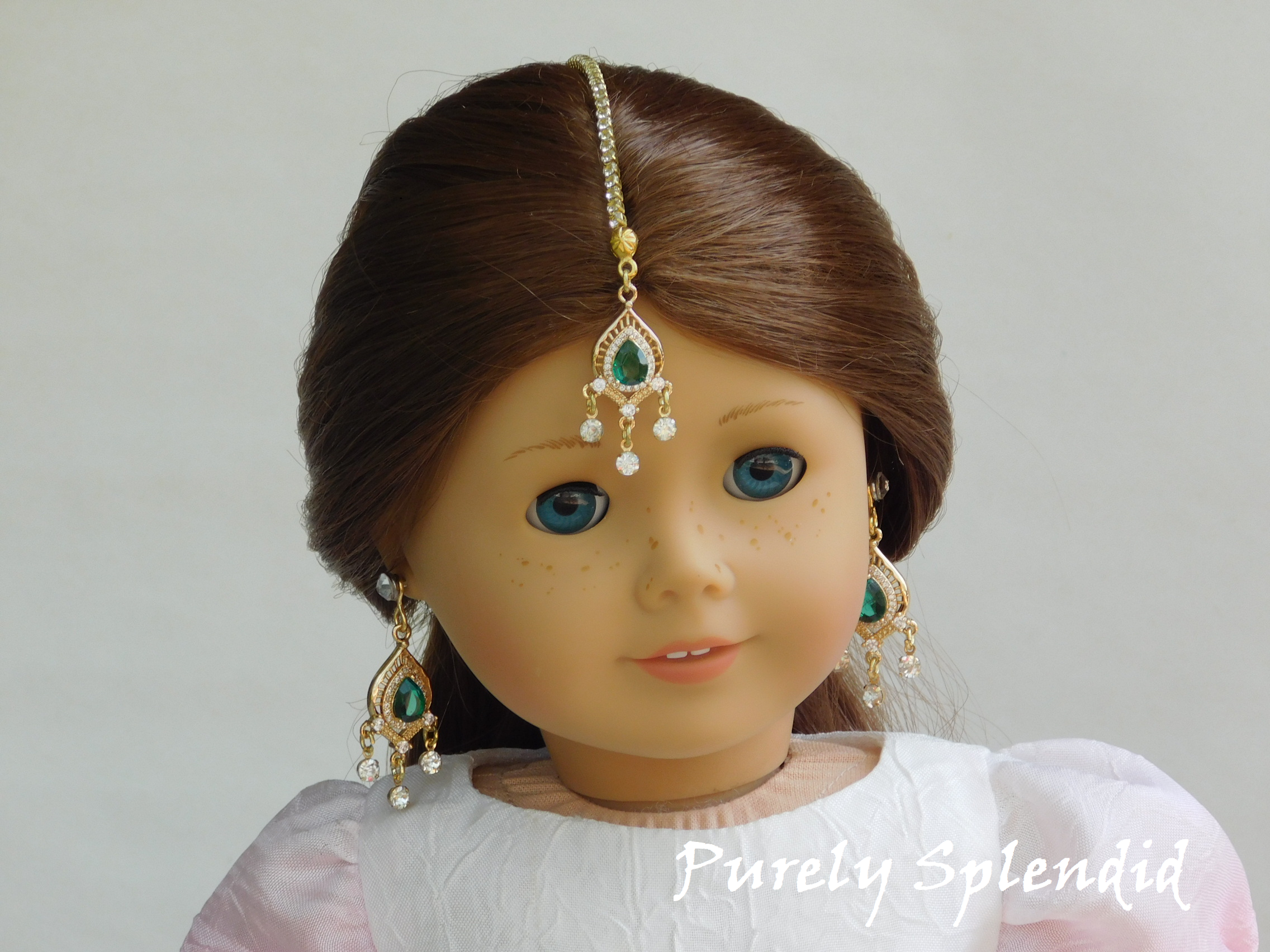 18 inch doll shown wearing an Emerald Green Maang Tikka with matching earrings