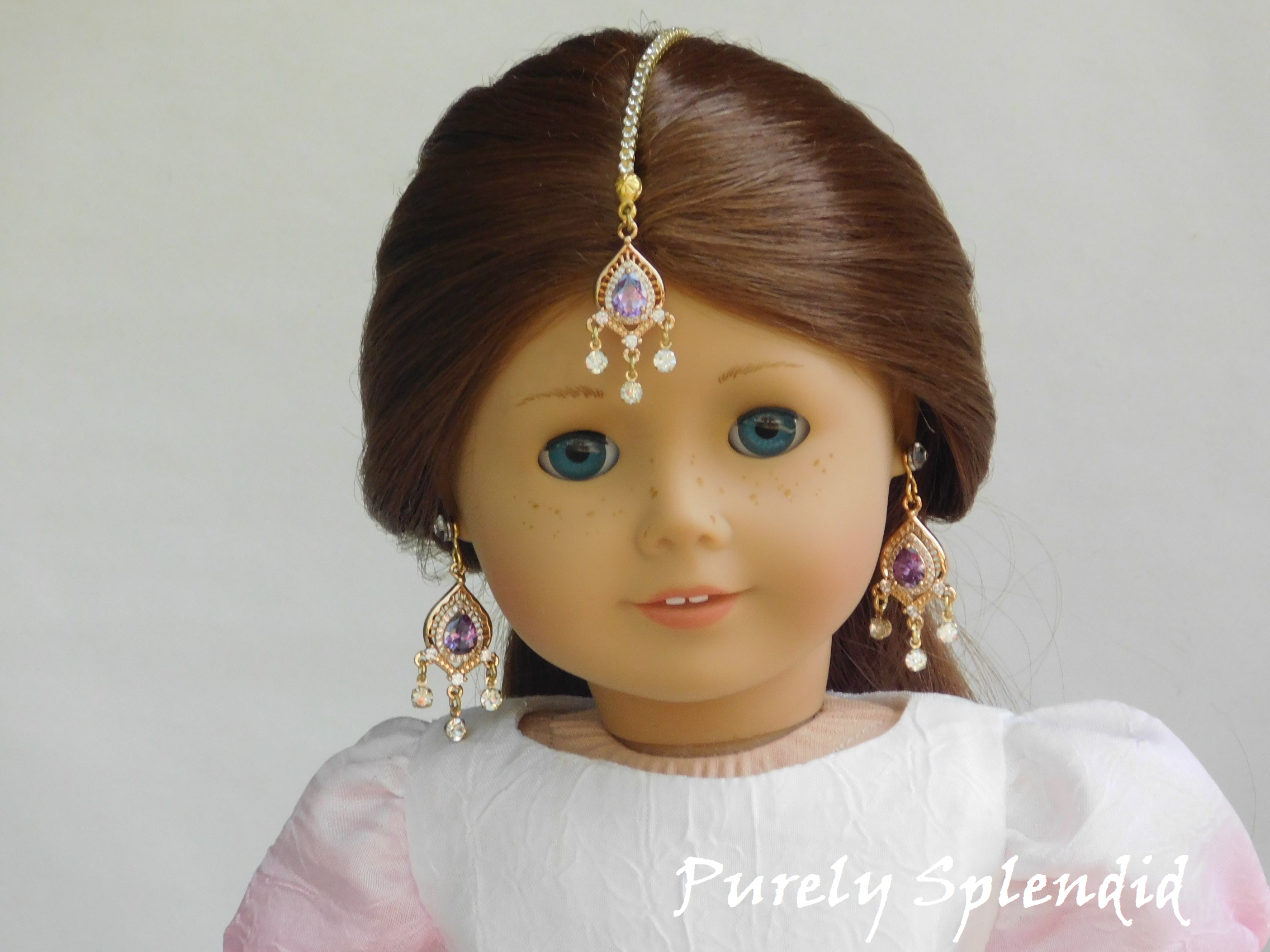 18 inch doll shown wearing purple Maang Tikka and matching earrings