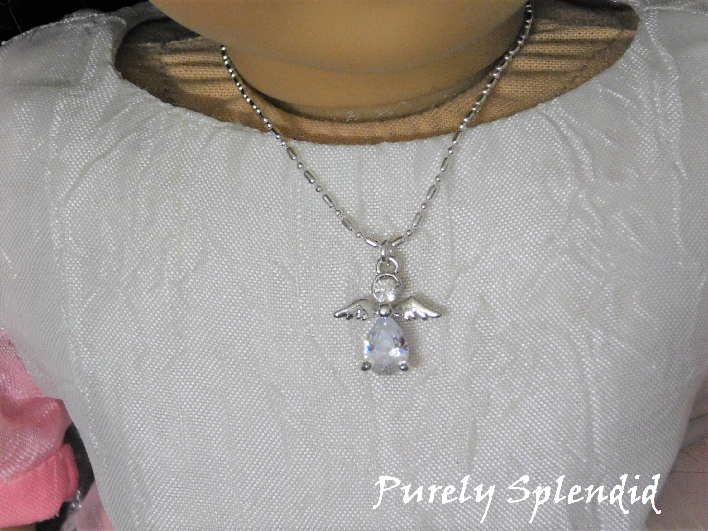 Dazzling Siler Angel Necklace shown on an 18 inch doll