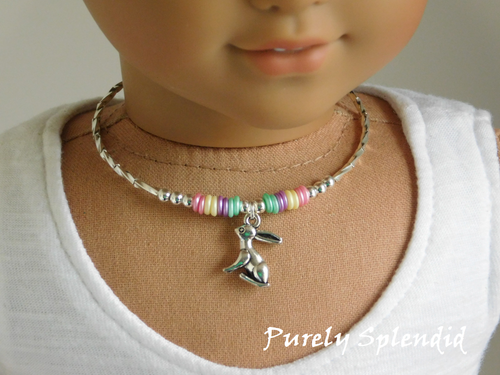 silver Easter bunny on a silver choker necklace with pale pink, pale yellow, pale purple and pale green beads for 18 inch dolls