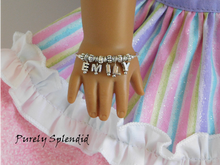 Load image into Gallery viewer, American Girl Doll shown wearing a Name Bracelet with the name Emily
