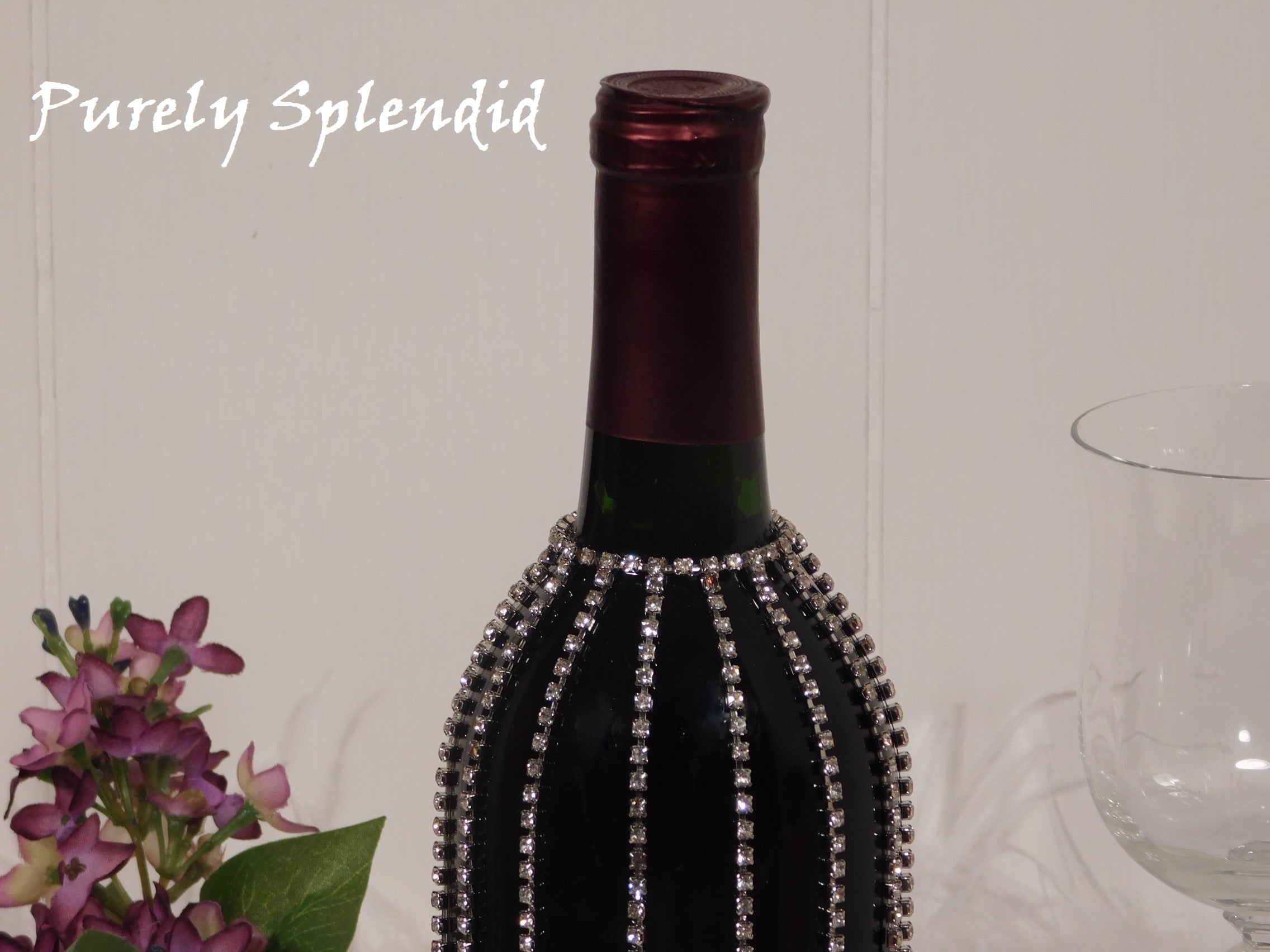 close up of the Sparkling Falling Rhinestone Bottle Bline on a standard dark wine bottle