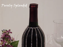Load image into Gallery viewer, close up of the Sparkling Falling Rhinestone Bottle Bline on a standard dark wine bottle
