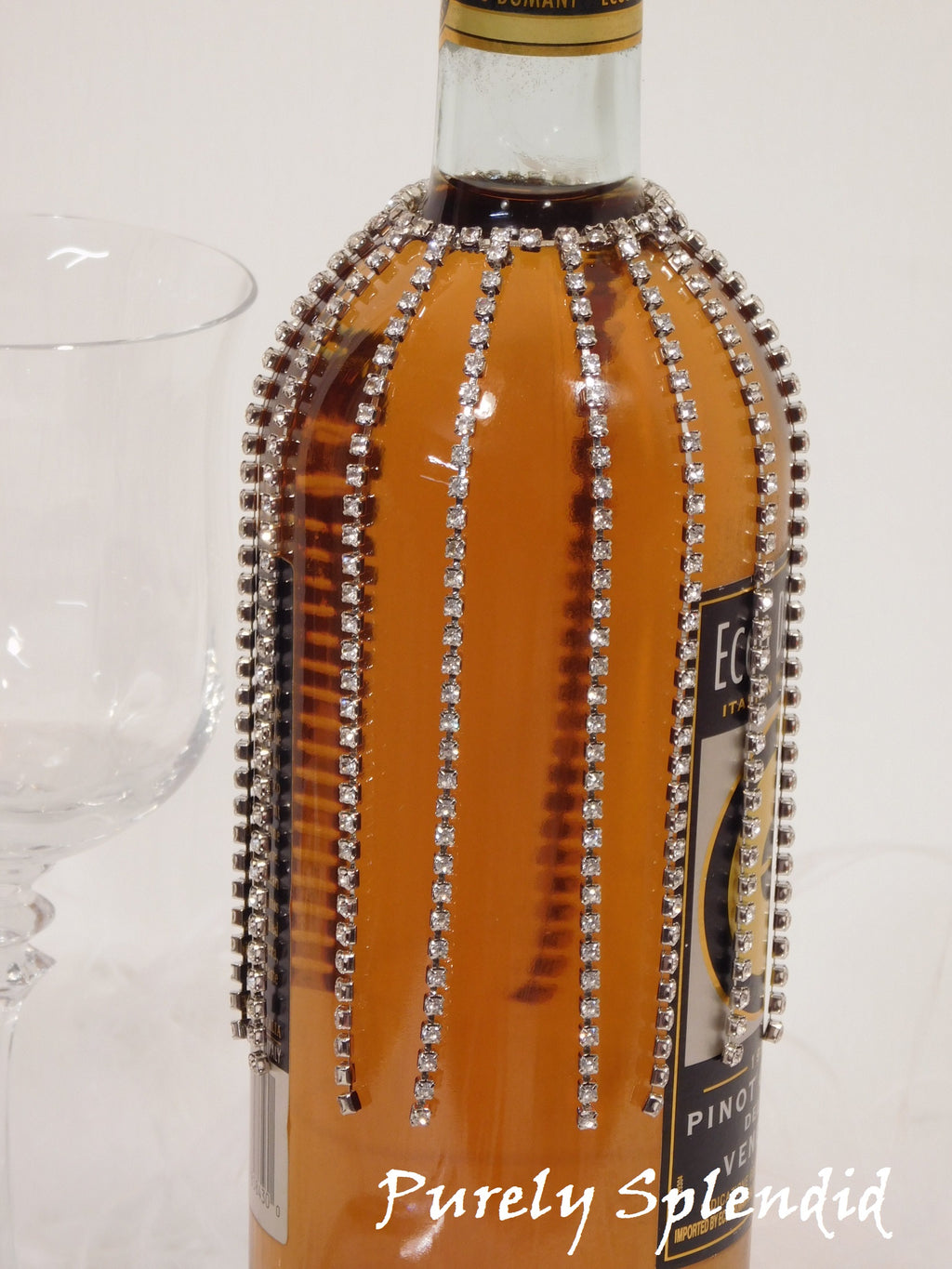 close up of the Sparkling Falling Rhinestone Bottle Bling on a standard clear wine bottle with white wine