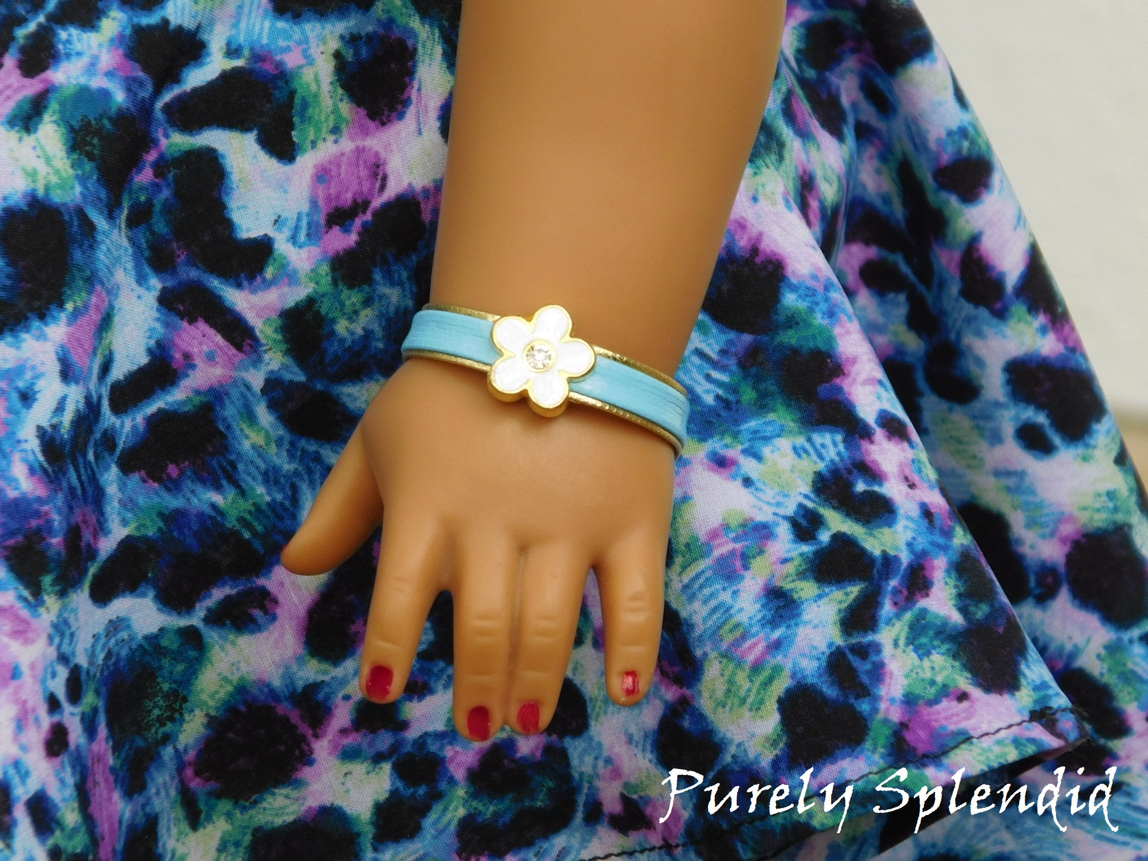 18 inch doll wearing a Blue Flower Bracelet