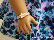 Load image into Gallery viewer, 18 inch doll who has a 3 1/4&quot; wrist wearing a Pink Flower Bracelet
