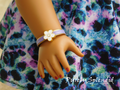 18 inch doll wearing a Purple Flower Bracelet