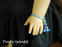 Load image into Gallery viewer, Blue and Green Friendship Bracelet shown on an 18 inch doll
