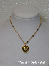 Load image into Gallery viewer, gold heart locket with a clear center crystal hanging from a pretty gold chain
