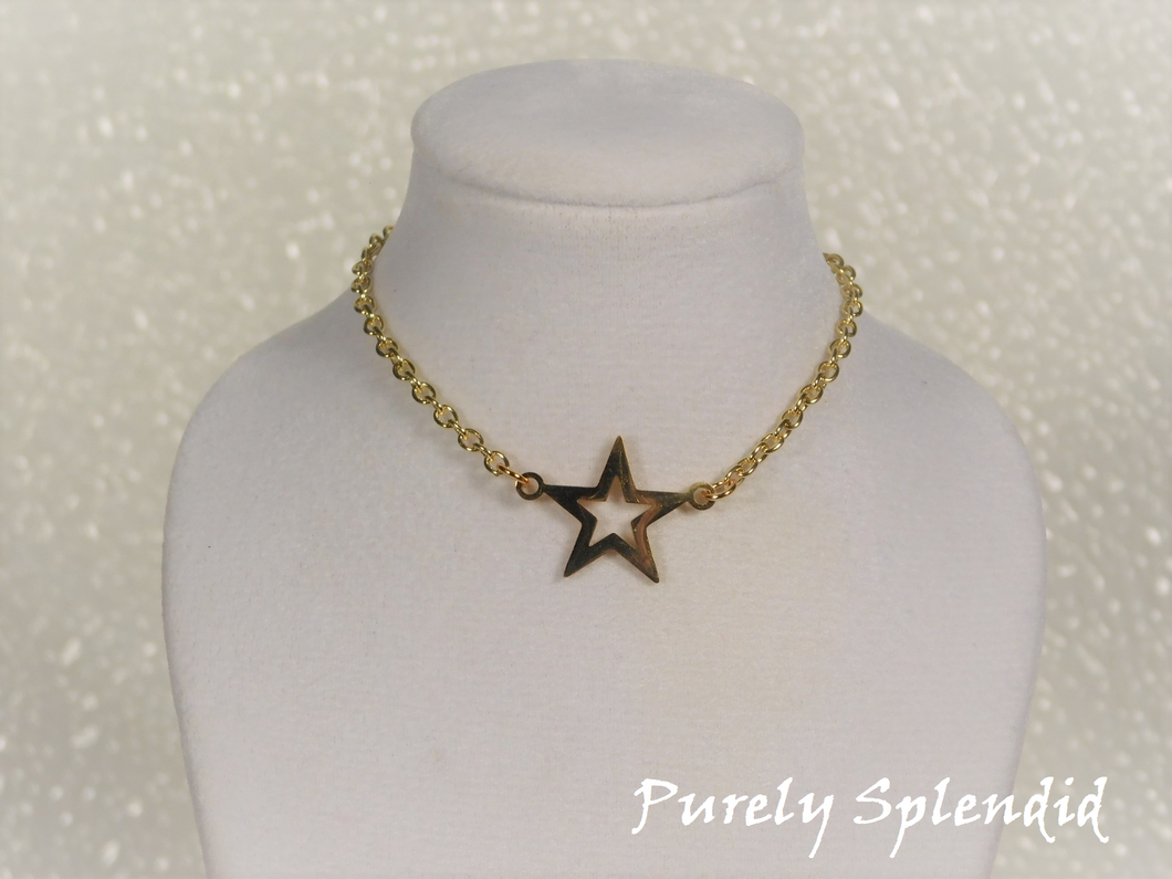 open gold colored star on a gold colored chain 