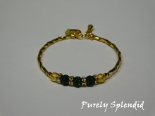 Load image into Gallery viewer, Gold bracelet with three round sparkling green beads each surrounded with a ring of sparkle
