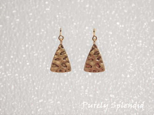 gold triangle earrings that have hammered marks on them